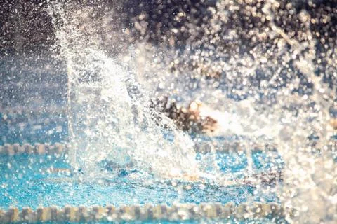 Blurry background of splash drop water on swimming race. Stock Photos