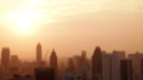 Blurry background warm sun light over silhouette city tall building Stock Footage 239605037