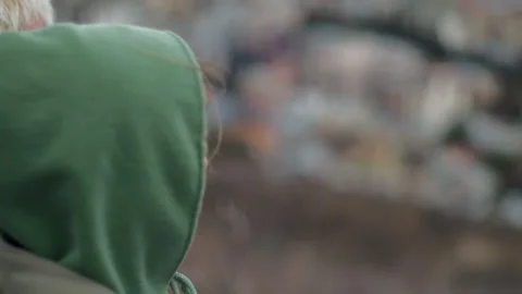 In blurry background, young persons sitting on the hill and observing cityscape Stock Footage 279939098