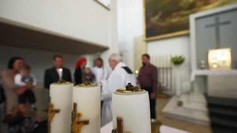 Blurry: Baptism process in a catholic church with priest and newborn's family Video stock 219901668