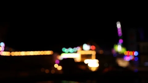 Blurry blinking lights of carnival faiground at night Stock Footage 120138559
