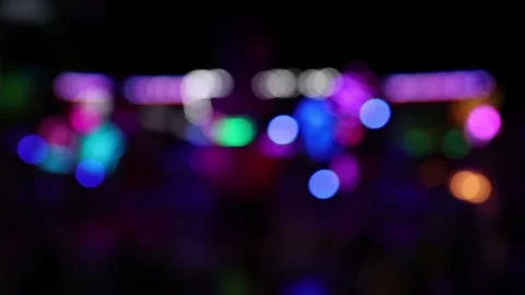 Blurry blinking lights of moving carousel ride at night Stock Footage 154649187