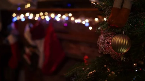 Blurry, blond boy hangs two Christmas stockings on mantle Stock Footage 99399767