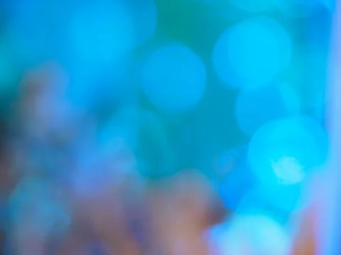 Blurry blue tone background with soft light bokeh. Abstract background. Stock Photos