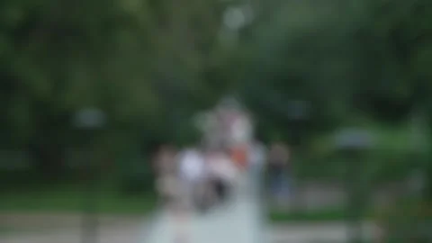 Blurry bokeh background of people walking in green summer park. Stock Footage 341135794