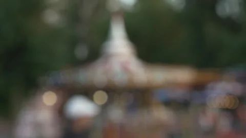 Blurry bokeh background of vintage carousel ride with glowing lights. Stock Footage 341136583