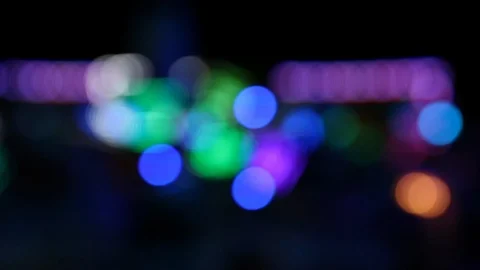 Blurry bokeh lights of moving carousel ride during the night Video stock 122512436