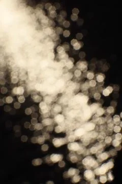 Blurry bokeh of sunset reflection in surface of lake as background Stock Photos