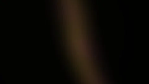 Blurry brown object on black background. Stock Footage 339998020