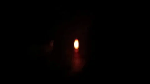 Blurry Candle Flame Glow in Total Darkness Stock Footage 333879059