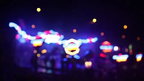 Blurry carousel ride in action during the night with flashing lights Stock Footage 154649210