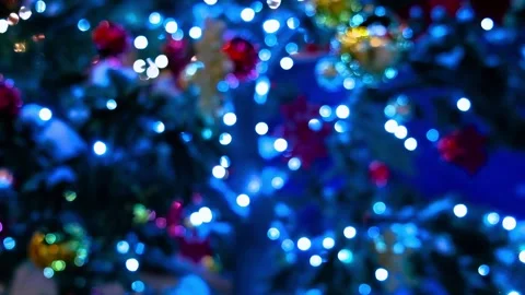 Blurry Christmas background. Christmas Tree with flashing garlands. New year and Stock Footage 160096439