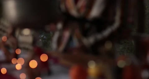 Blurry Christmas lights background and moving into focus on hands cooking Stock Footage 165387006