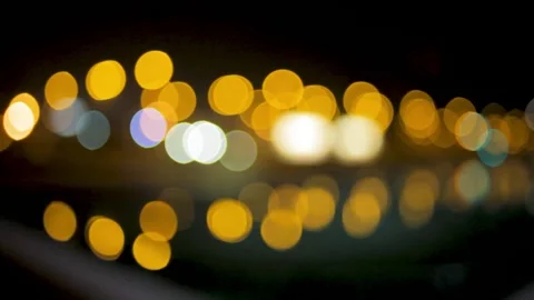 Blurry city lights slightly blinking on a lake at night Stock Footage 134248143