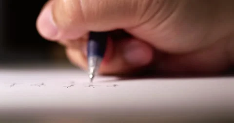 Blurry close-up of an individual's hand while scribbling some notes using Stock Footage 277196624