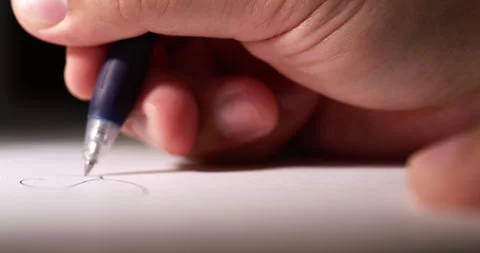 Blurry close-up of an individual's hand while scribbling some notes using Stock Footage 281259163