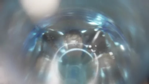Blurry close up view looking inside a blue plastic bottle Stock Footage 332982488
