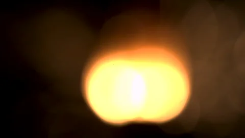 Blurry Close View of a Yellow Light from a Sparkler Against a Black Background Stock Footage 270393160