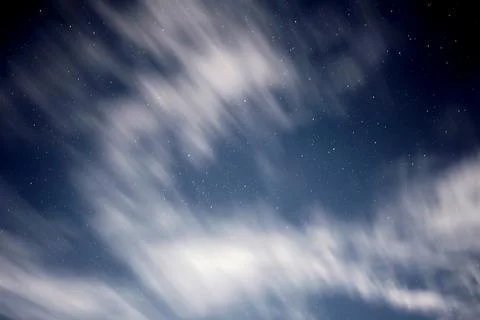 Blurry clouds floating in the sky during evening with stars. Stock Photos