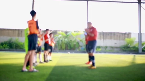 Blurry coach standing and touch hands with kid soccer player Stock Footage 107183389