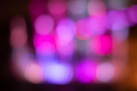 Blurry colored lights with bokeh effect. New Year Christmas. Background Stock Photos
