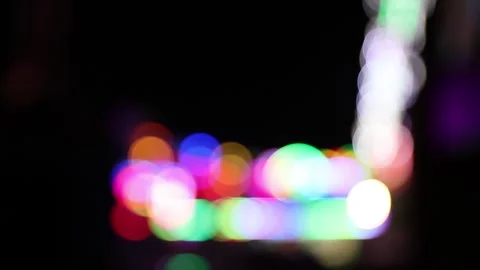 Blurry colorful blinking lights of fair during the night Stock Footage 154649173