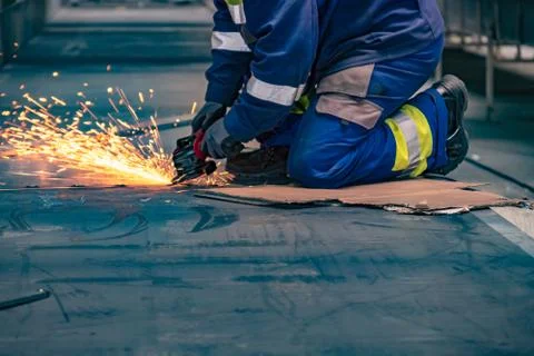 Blurry construction concept background of worker using angle grinder on Stock Photos