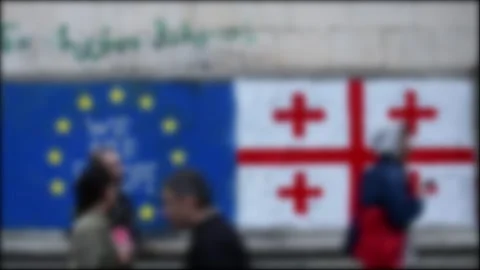 Blurry copy space banner background Georgian and EU Flag on wall with writt.. Vídeo Stock 277842646