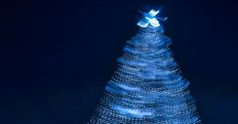 Blurry creative lighted christmas tree banner in monochrome classic blue palette Stock Photos