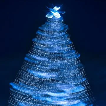 Blurry creative lighted christmas tree in monochrome classic blue palette on a Stock Photos