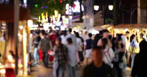 Blurry crowd of people walking at Kunming night market Stock Footage 329624982