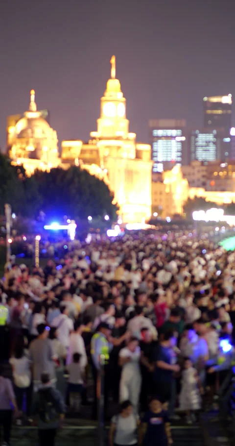 Blurry crowd of people walking at night on famous Bund embankment Stock Footage 327649477