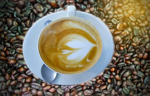 Blurry Cup of coffee on beans. Stock Photos