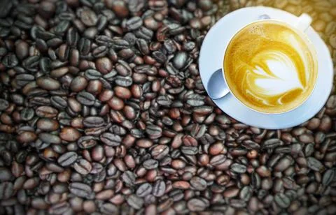 Blurry Cup of coffee on beans. Stock Photos