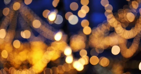 Blurry, defocused, bokeh balls effect of hanging string lights at night Stock Footage 321672668