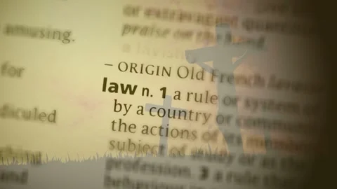 Blurry dictionary text drifting starting focus shift crucifix staying as letters Stock Footage 329812448