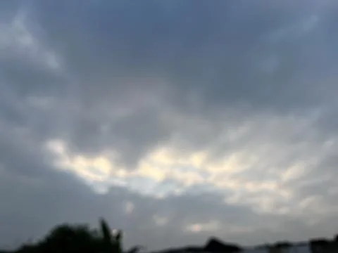 Blurry Dramatic Sky with Dark Storm Clouds and Sunlight Stock Photos