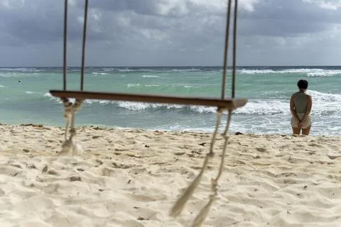 A blurry empty swing overlooking the caribbean sea Fotos de archivo