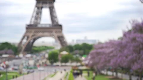 Blurry far away view of Eiffel Tower with bustling Paris street in view Stock Photos