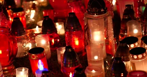 From blurry to focused candles during All Saints' Day in the evening Stock Footage 292254803