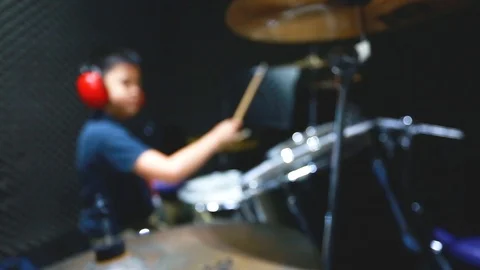 Blurry image of Asian boy put blue tshirt and red headphone learning and play Stock Footage 111867957