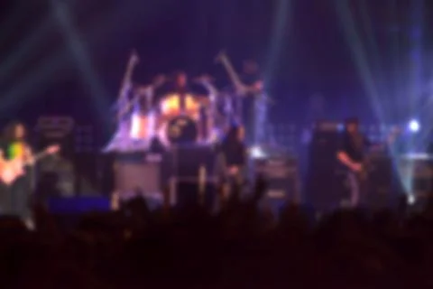 Blurry image background of musicians rock in big rock concert. Stock Photos