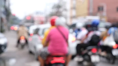 A blurry image of a busy street with a person wearing a blue helmet Stock Footage 295106923