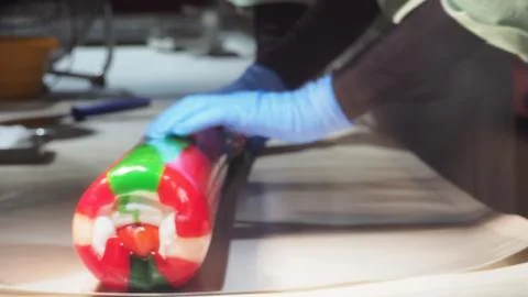Blurry image of Candy Making with hand is rolling a caramelize syrup. The col Stock Photos