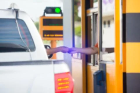 Blurry image of driver pay for the expressway. Man pays money to a cashier fo Stock Photos