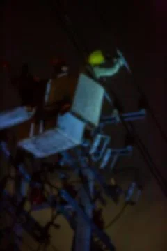 Blurry image of electrical worker is connecting high-voltage cable  with a cr 写真素材