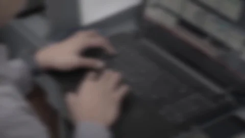 BLURRY IMAGE OF MAN WORKING ON LAPTOP Stock Footage 107028559