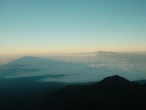 A blurry image of a mountain range with a cloudy sky Stock Photos