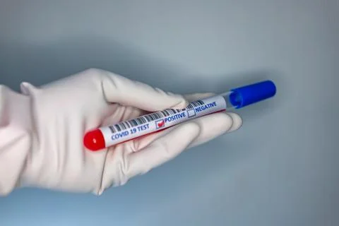 Blurry image of a nurse hands while holding a test tube containing a patients Stock Photos