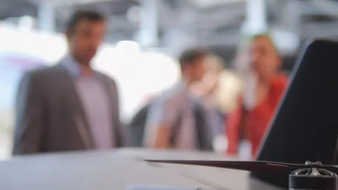 Blurry image of people talking and a laptop Stock Footage 310838729